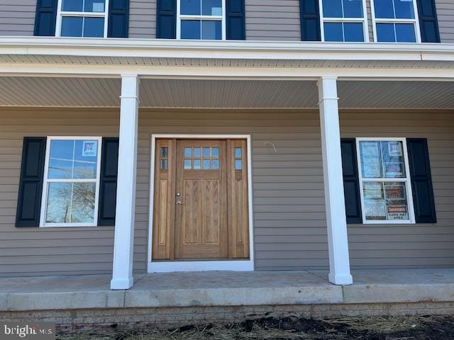 view of exterior entry featuring a porch