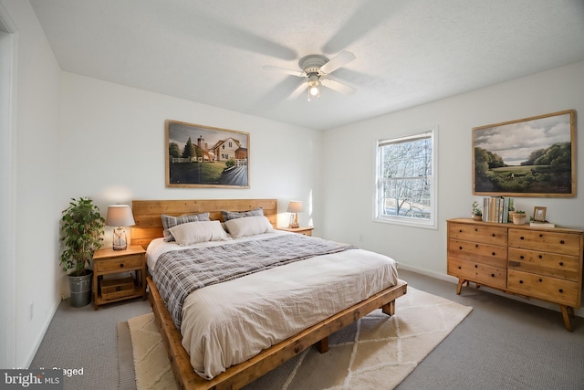 carpeted bedroom featuring ceiling fan and baseboards