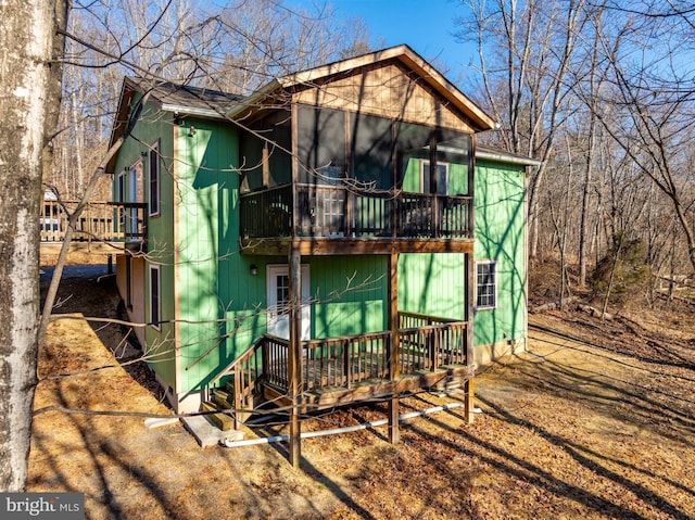 back of house with a sunroom