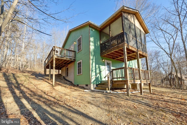 view of front of home featuring crawl space and a deck