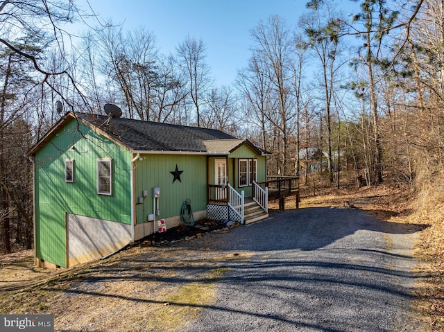 rustic home with driveway, crawl space, and roof with shingles