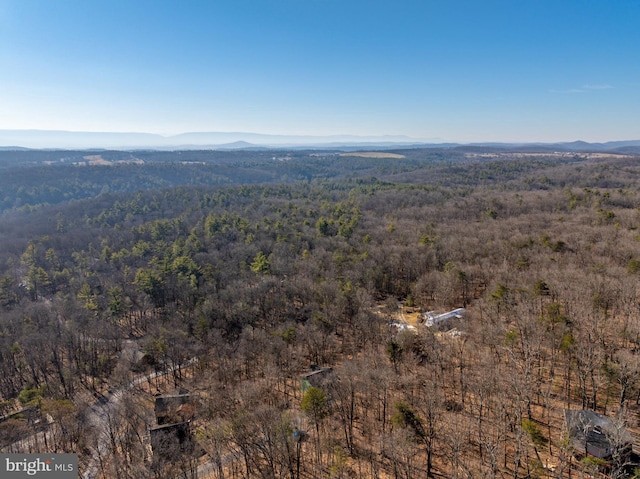 aerial view with a wooded view and a mountain view