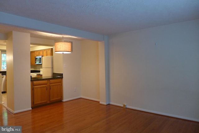 interior space with wood finished floors and baseboards