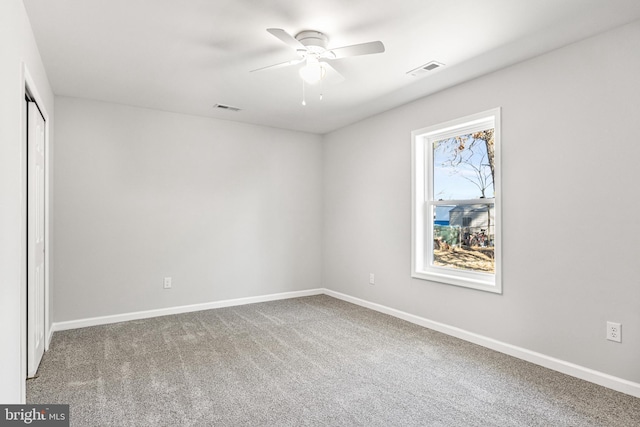 unfurnished bedroom featuring carpet floors, visible vents, and baseboards