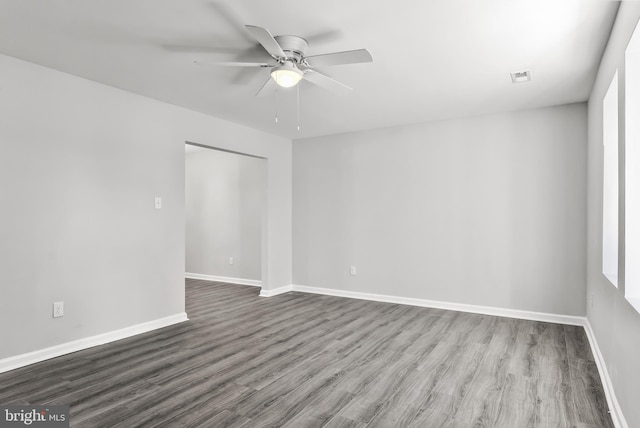 spare room with ceiling fan, baseboards, and wood finished floors