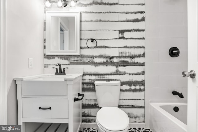 full bathroom featuring washtub / shower combination, vanity, and toilet