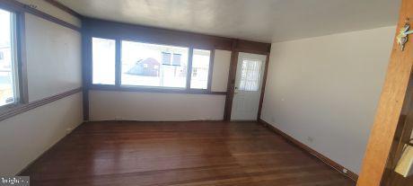 spare room with wood finished floors and baseboards