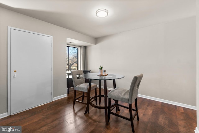 dining room with baseboards and wood finished floors