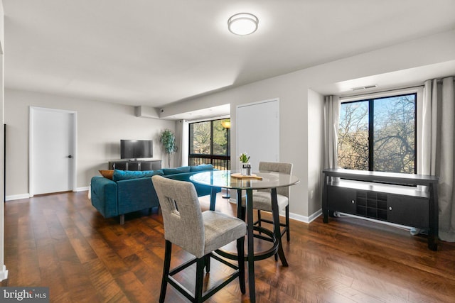 dining area featuring wood finished floors and baseboards