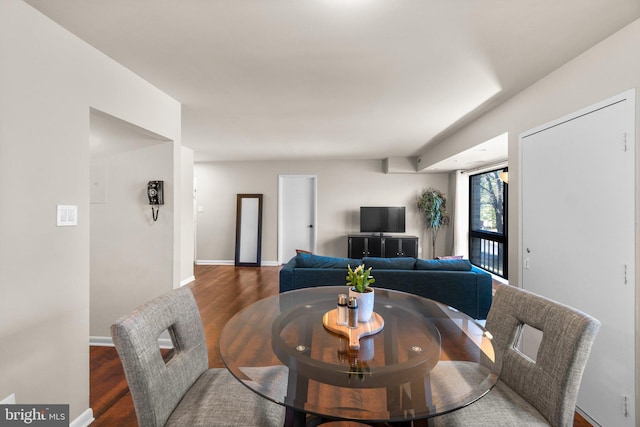 dining area featuring baseboards and wood finished floors