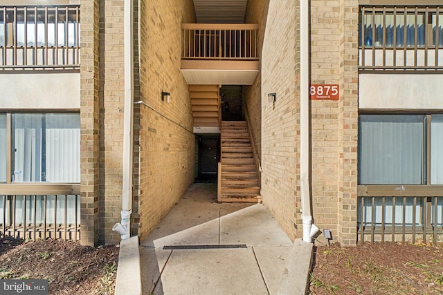 doorway to property with brick siding