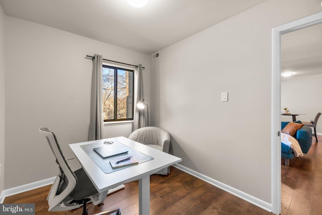 office space with visible vents, baseboards, and wood finished floors