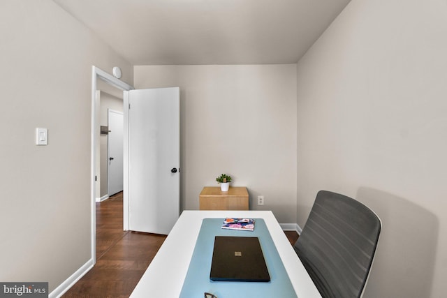 office space with dark wood-type flooring and baseboards