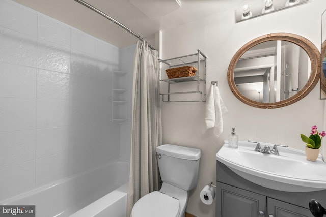 full bath featuring shower / bathtub combination with curtain, toilet, and vanity