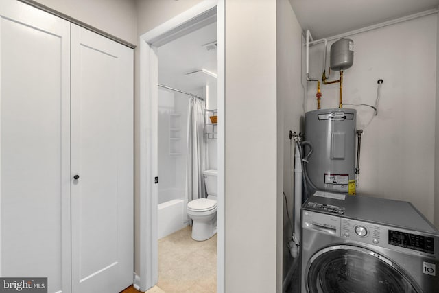 laundry area featuring tile patterned floors, laundry area, washer / dryer, and electric water heater