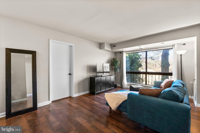 living area featuring visible vents, baseboards, and dark wood-style flooring