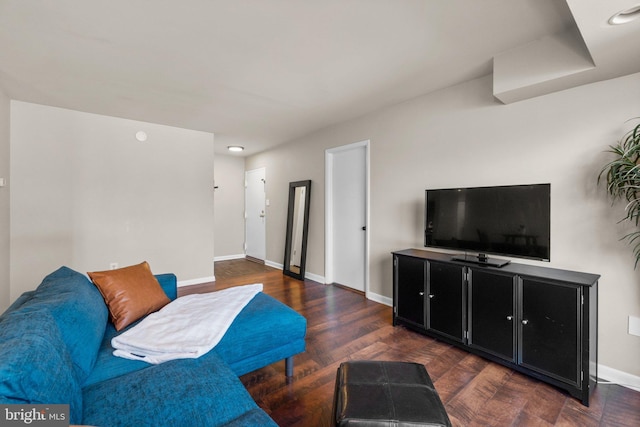 living area featuring baseboards and wood finished floors