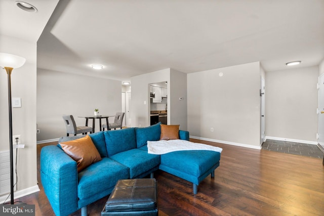 living area with baseboards and wood finished floors