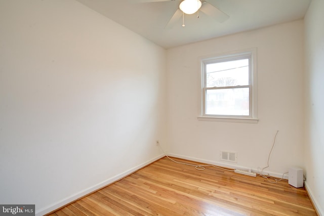 unfurnished room with baseboards, a ceiling fan, visible vents, and light wood-type flooring