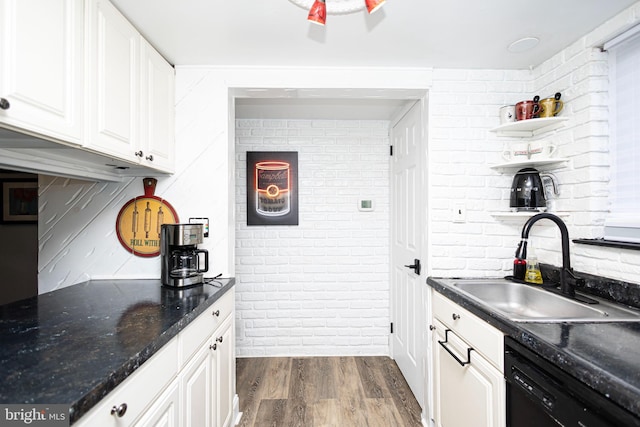 kitchen with open shelves, dark wood-type flooring, white cabinetry, a sink, and dishwasher