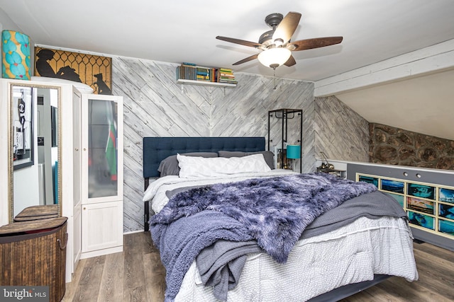 bedroom featuring vaulted ceiling with beams, a ceiling fan, and wood finished floors