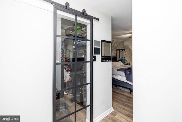 interior space featuring wood finished floors and a barn door