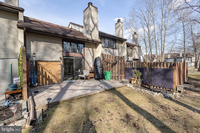 back of property with a patio area and fence