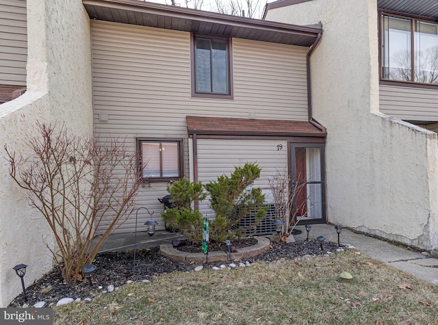 view of exterior entry with stucco siding