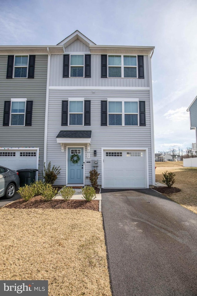 view of property featuring aphalt driveway and an attached garage