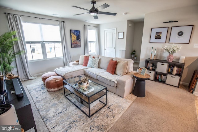 carpeted living area featuring visible vents, baseboards, and ceiling fan