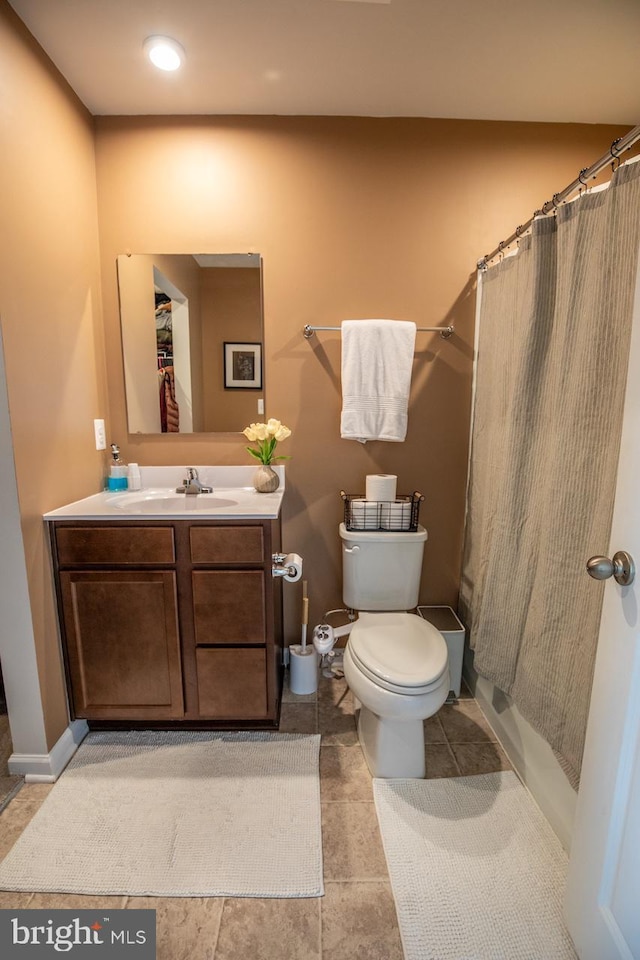 full bathroom with a shower with shower curtain, toilet, vanity, and tile patterned floors