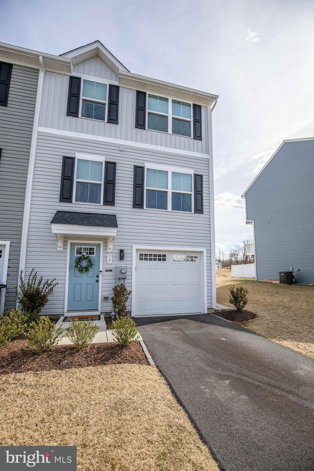 view of front of home featuring aphalt driveway, an attached garage, and board and batten siding