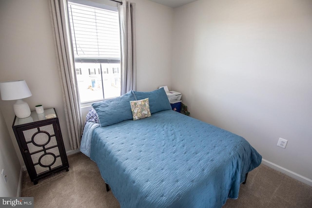 carpeted bedroom featuring baseboards