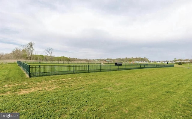 view of yard featuring a rural view and fence