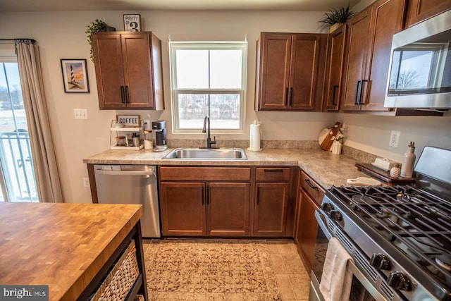 kitchen featuring a sink, wood counters, and appliances with stainless steel finishes