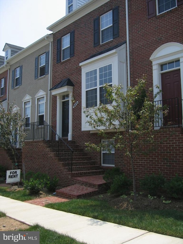 view of property featuring brick siding