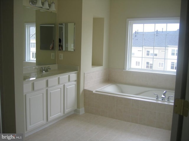 full bath featuring double vanity, a sink, and a bath