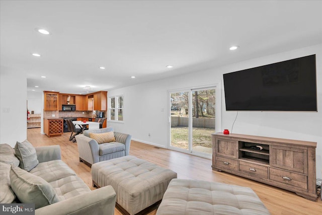 living area featuring recessed lighting and light wood finished floors