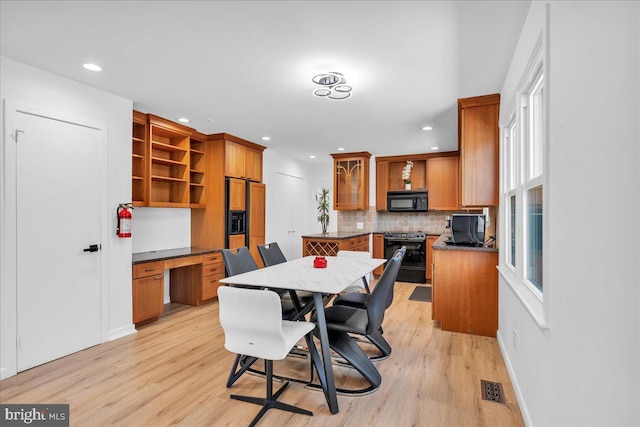 dining space with visible vents, recessed lighting, light wood-type flooring, and built in desk