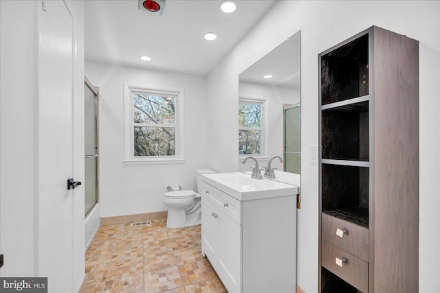 bathroom with visible vents, toilet, stone finish floor, recessed lighting, and vanity