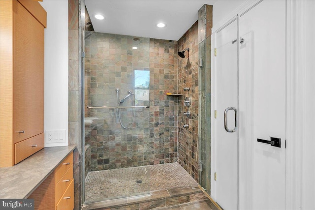 full bathroom featuring recessed lighting and a shower stall