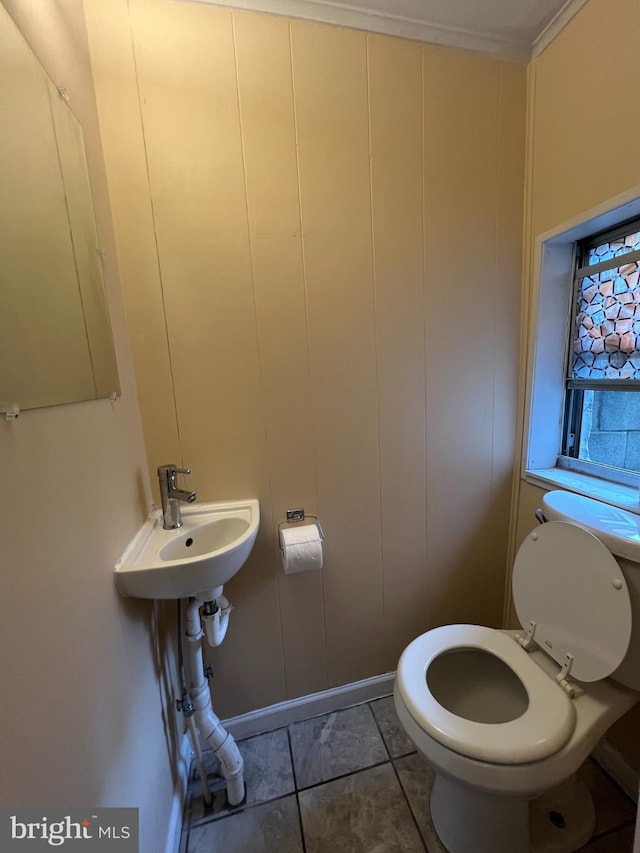 bathroom featuring tile patterned flooring, a sink, and toilet