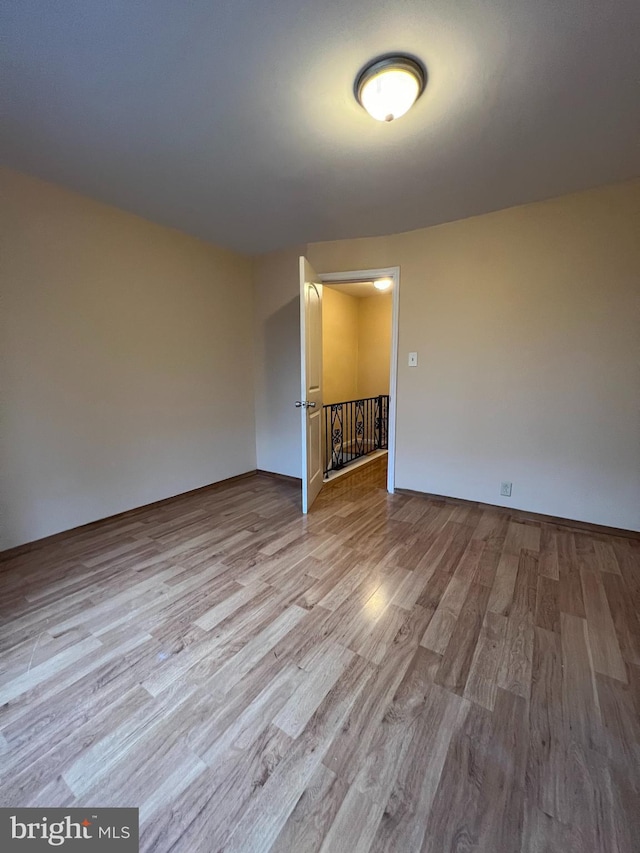 spare room featuring wood finished floors