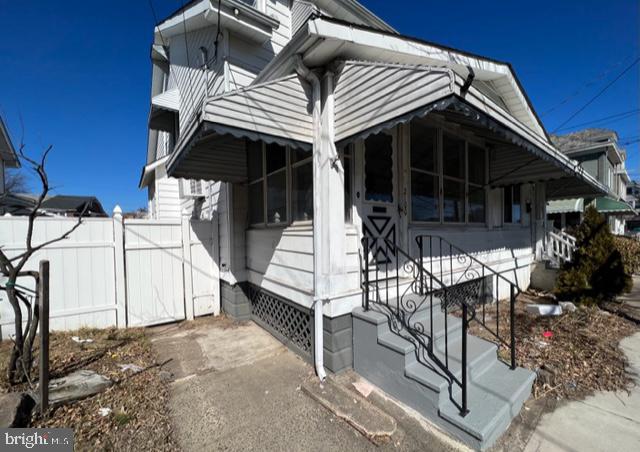 view of side of property featuring fence