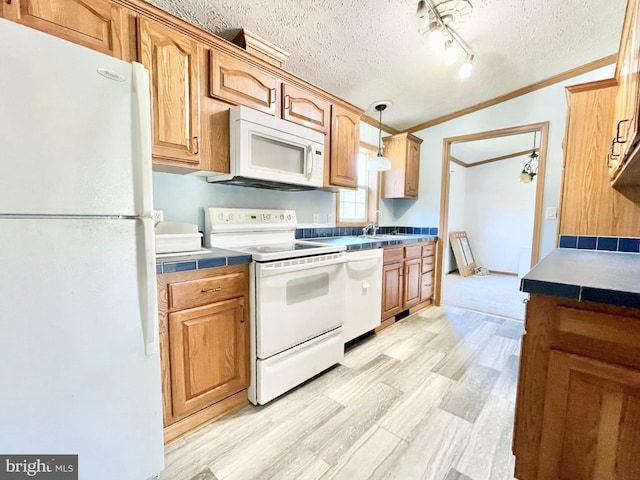 kitchen featuring light wood-style flooring, white appliances, ornamental molding, and a textured ceiling