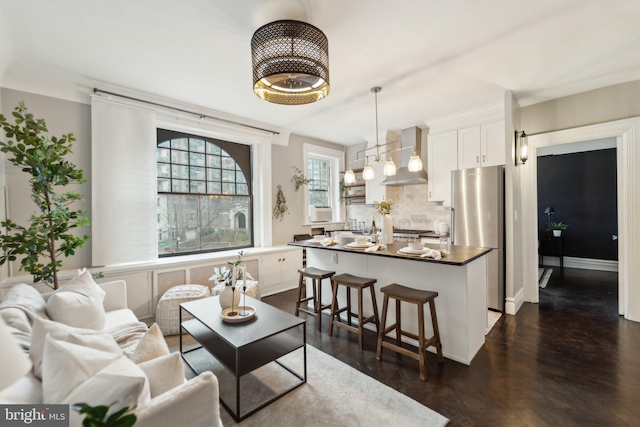 living room featuring baseboards and dark wood-style flooring