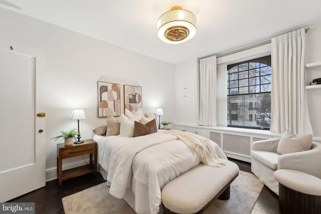 bedroom featuring wood finished floors and baseboards