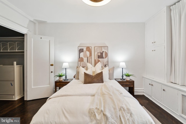 bedroom with dark wood-type flooring