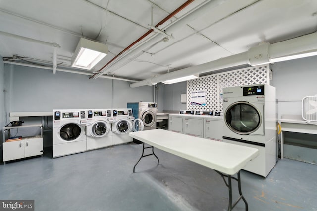 community laundry room featuring washer and dryer and a workshop area