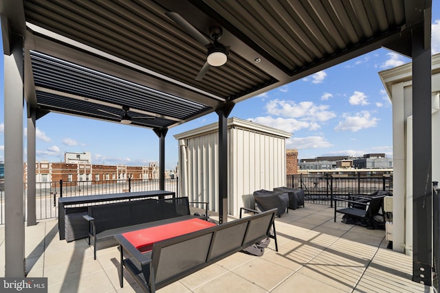 view of patio featuring a balcony, a city view, and a ceiling fan